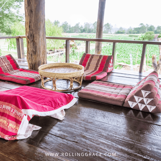 Traditional floor cushion seating with Khantoke tray and Lanna textiles at a Khantoke dinner in Chiang Mai