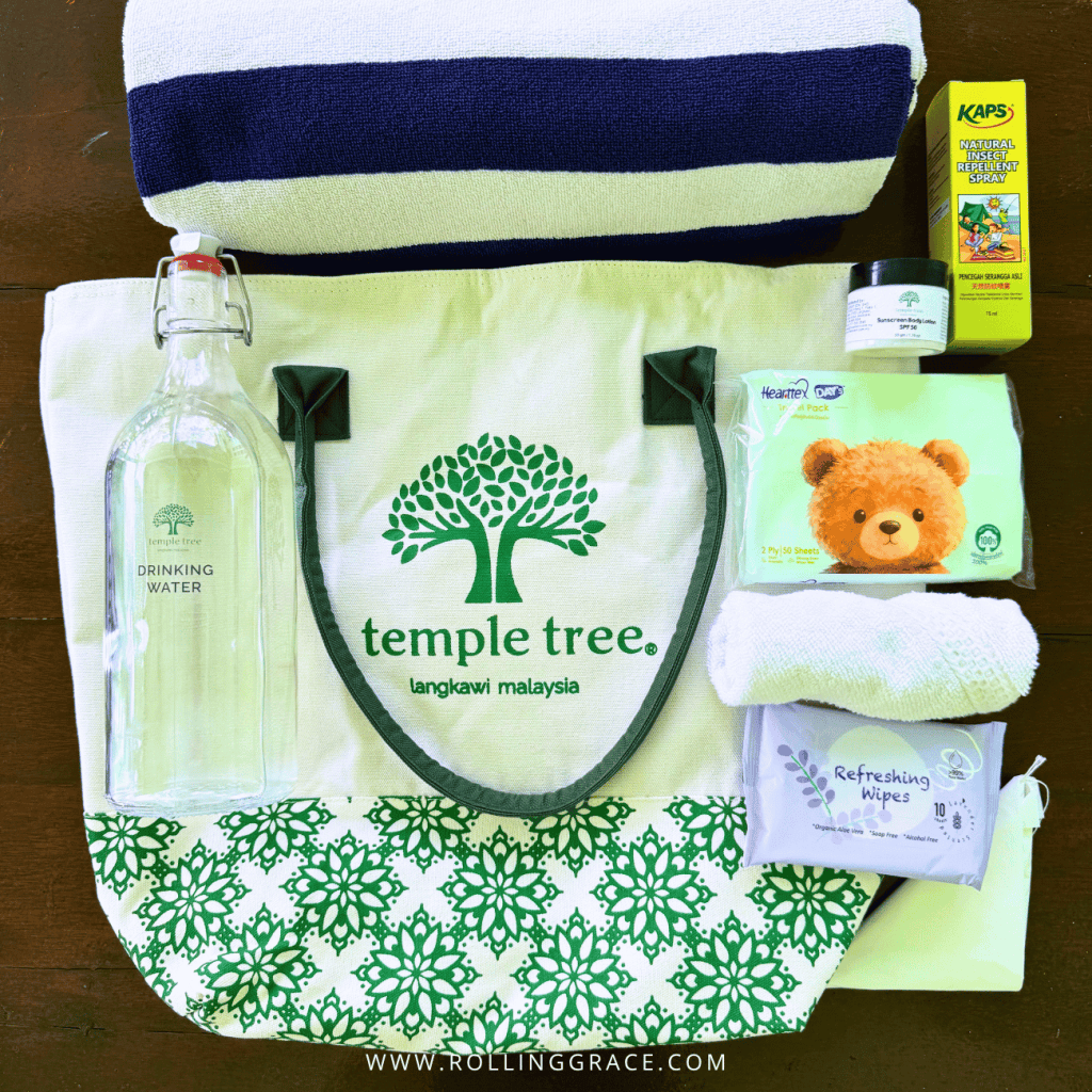 Temple Tree Beach Bag with a striped towel, water bottle and beach essentials from Temple Tree Resort Langkawi
