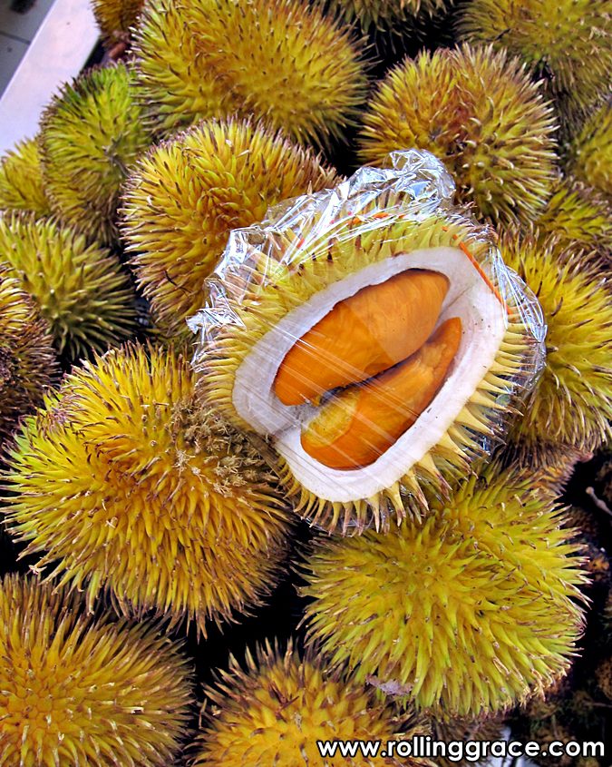 Orange-fleshed Durian Dalit among whole wild durians at a Borneo market