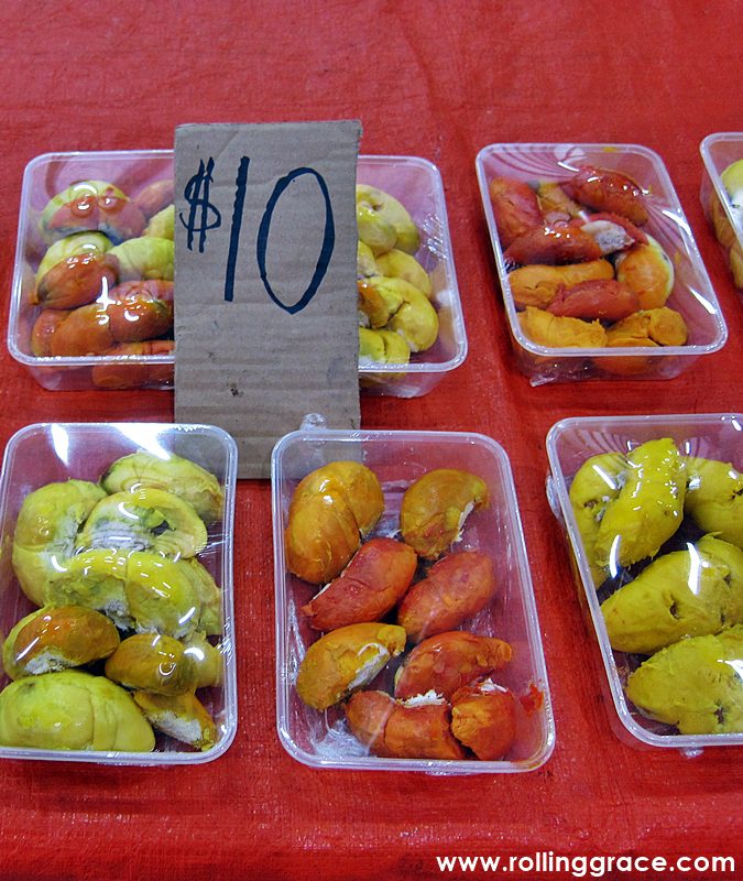 Whole green wild durians with RM10 price tag on sale at a Borneo market by Rolling Grace