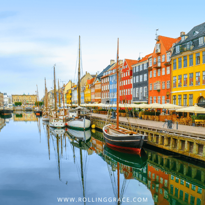 Colourful Nyhavn waterfront houses reflected in the canal in Copenhagen Denmark one of the safest countries for solo female travel