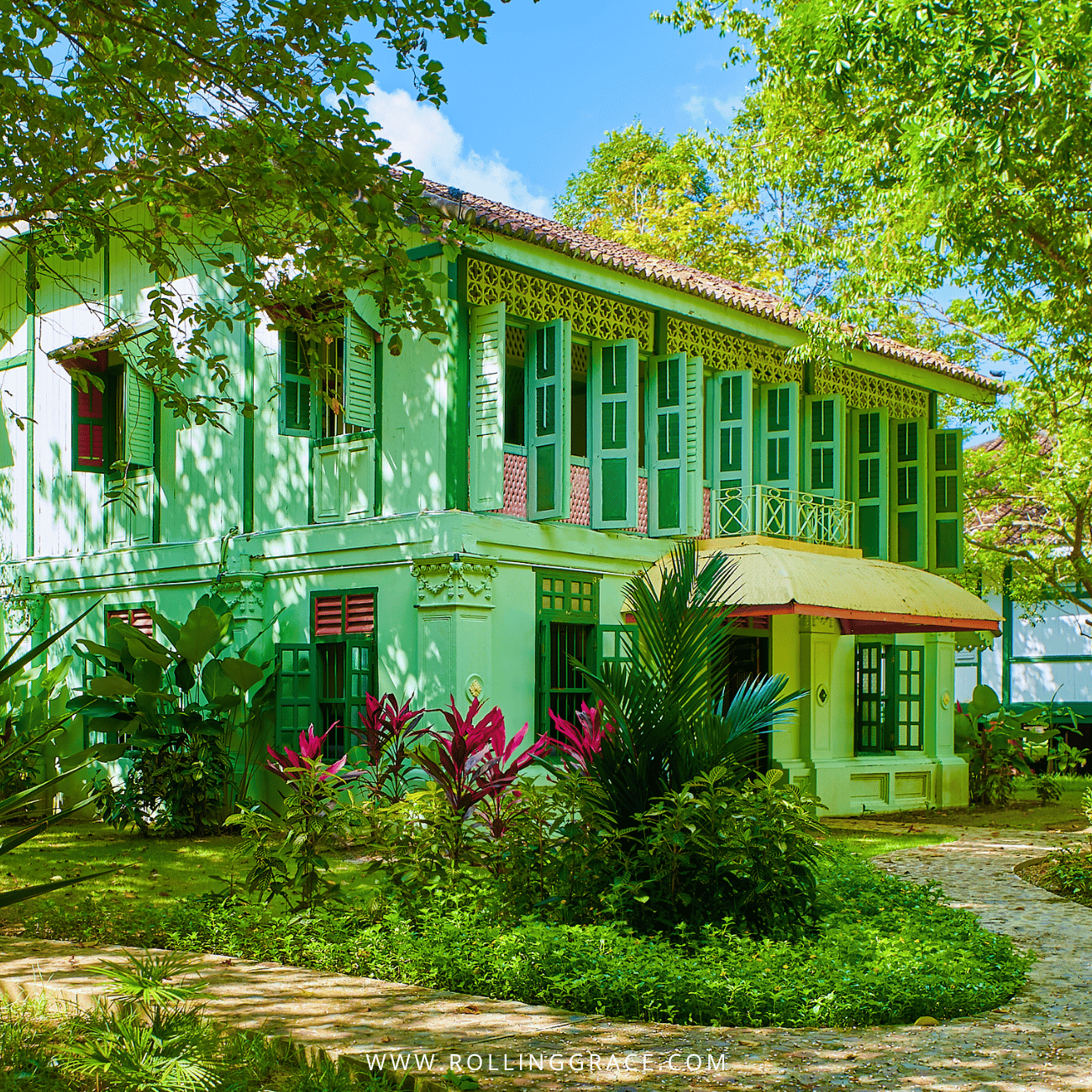 Green and white Colonial House with timber shutters in the gardens of Temple Tree Resort Langkawi