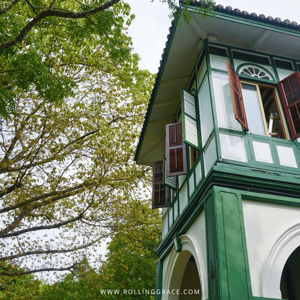Green and white upper storey of the Ipoh House framed by trees at Temple Tree Resort Langkawi