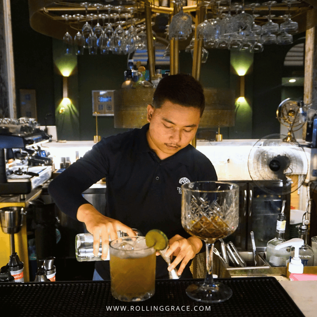 Bartender mixing a cocktail at the bar of Paloh Restaurant & Bar, Temple Tree Resort Langkawi