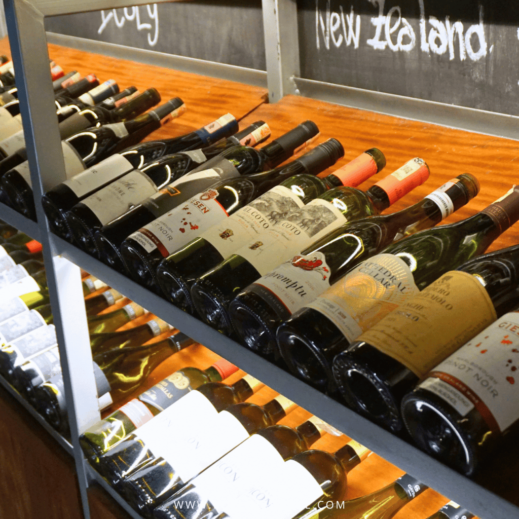 Wine bottles racked under chalkboard country labels at Paloh Restaurant & Bar, Temple Tree Resort Langkawi