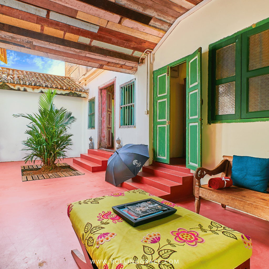 Semi-open courtyard with green shutters and red steps in the Plantation House, Temple Tree Resort Langkawi