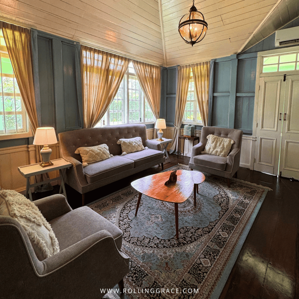 Straits House living room with grey sofas, armchairs and a round coffee table at Temple Tree Resort Langkawi