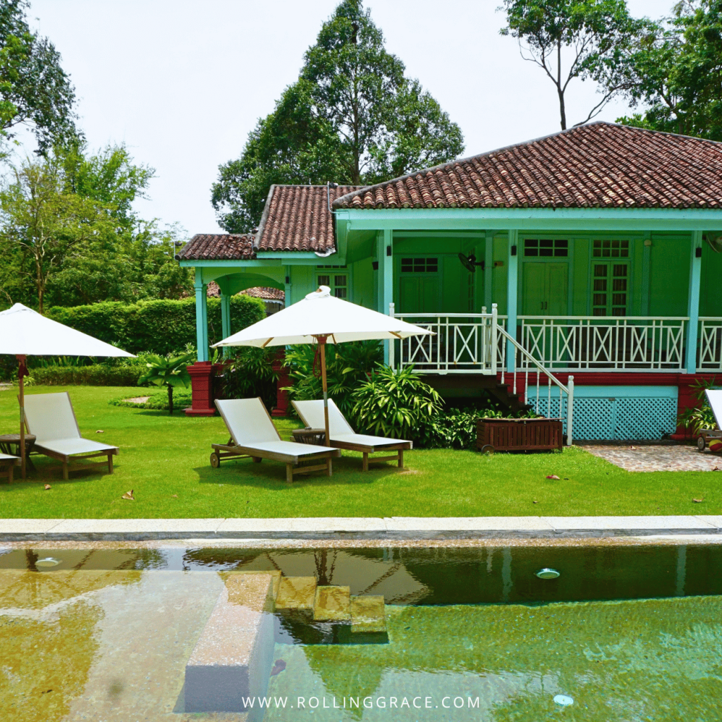 Green and white Straits House behind its private pool and loungers at Temple Tree Resort Langkawi