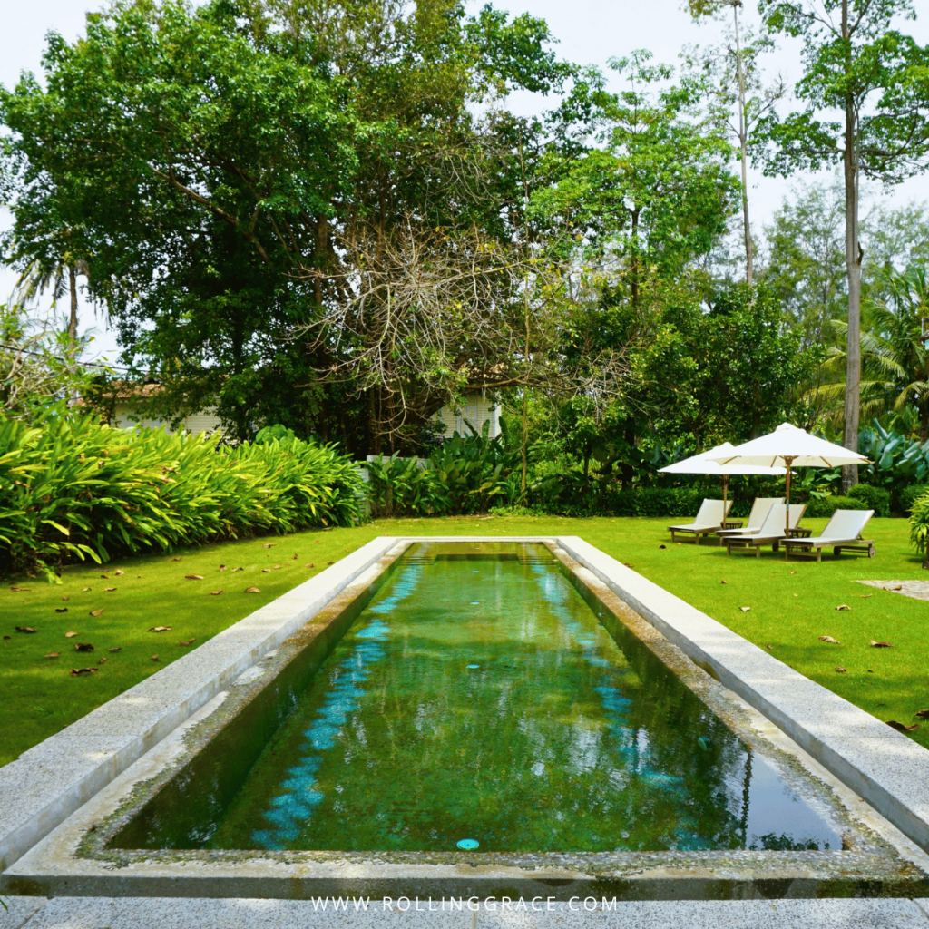 Private pool in the lawn of the Straits House with loungers and parasols, Temple Tree Resort Langkawi