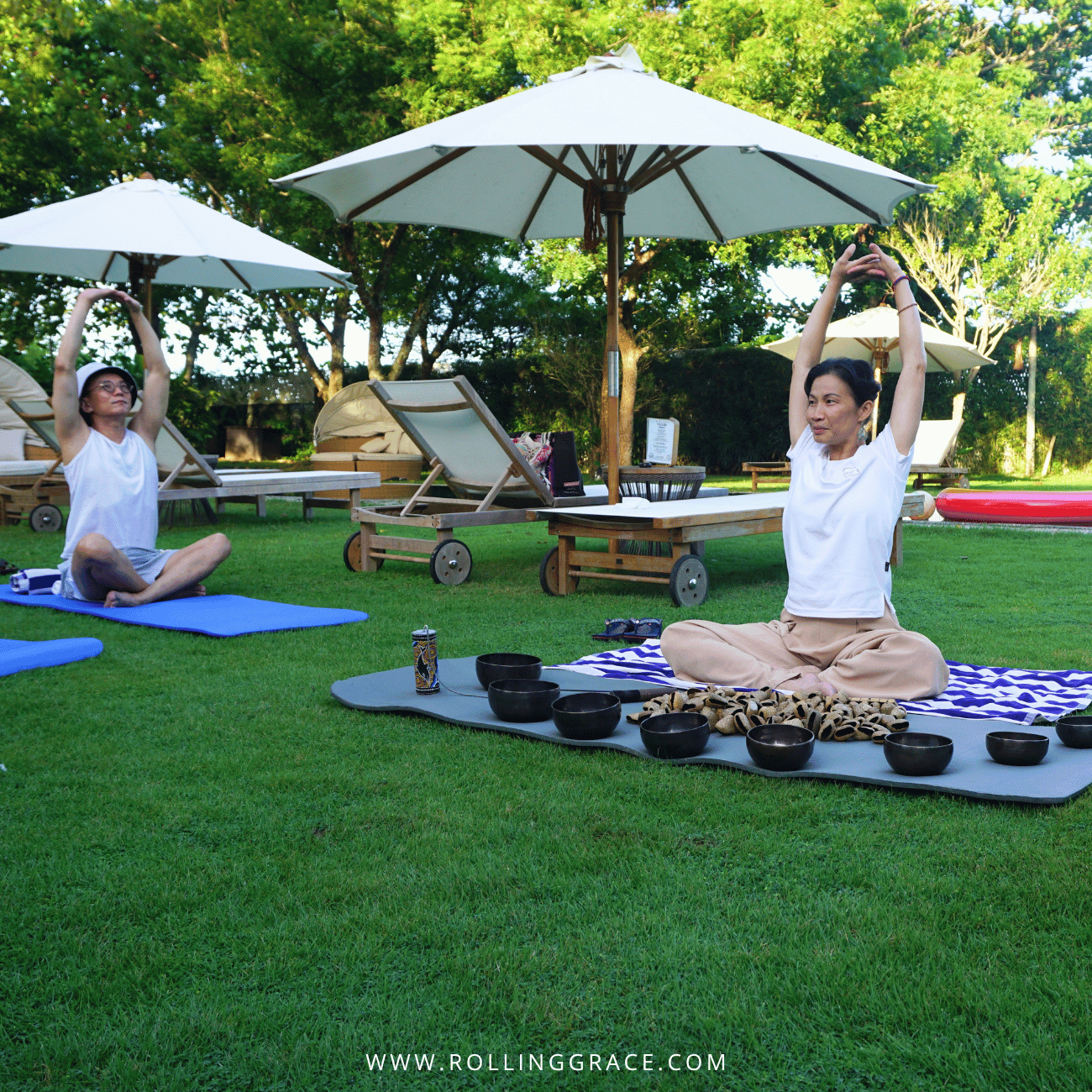 Yoga and sound healing with singing bowls on the lawn at Temple Tree Resort Langkawi