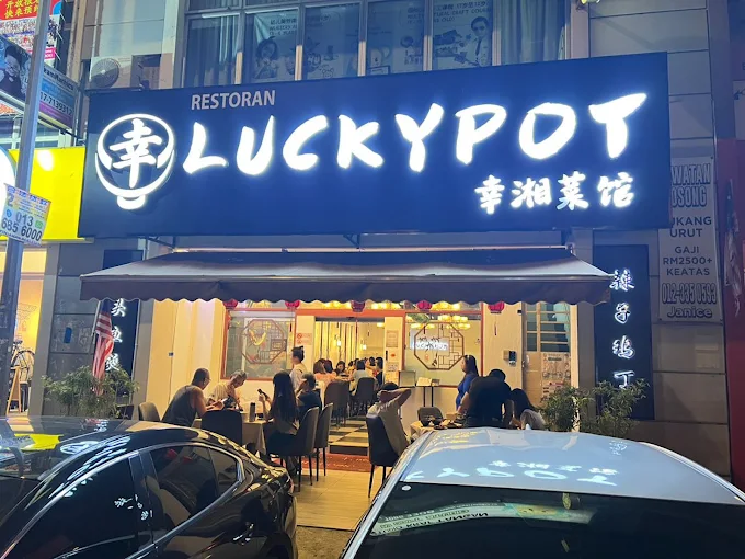 Lit shopfront and signboard of Luckypot at night on Lorong Batu Nilam 21A, Bukit Tinggi Klang