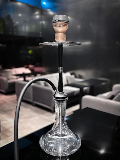 Glass hookah on a table in the dim, sofa-lined lounge at FOOM Lounge, Taman Pelangi, for shisha in Johor Bahru