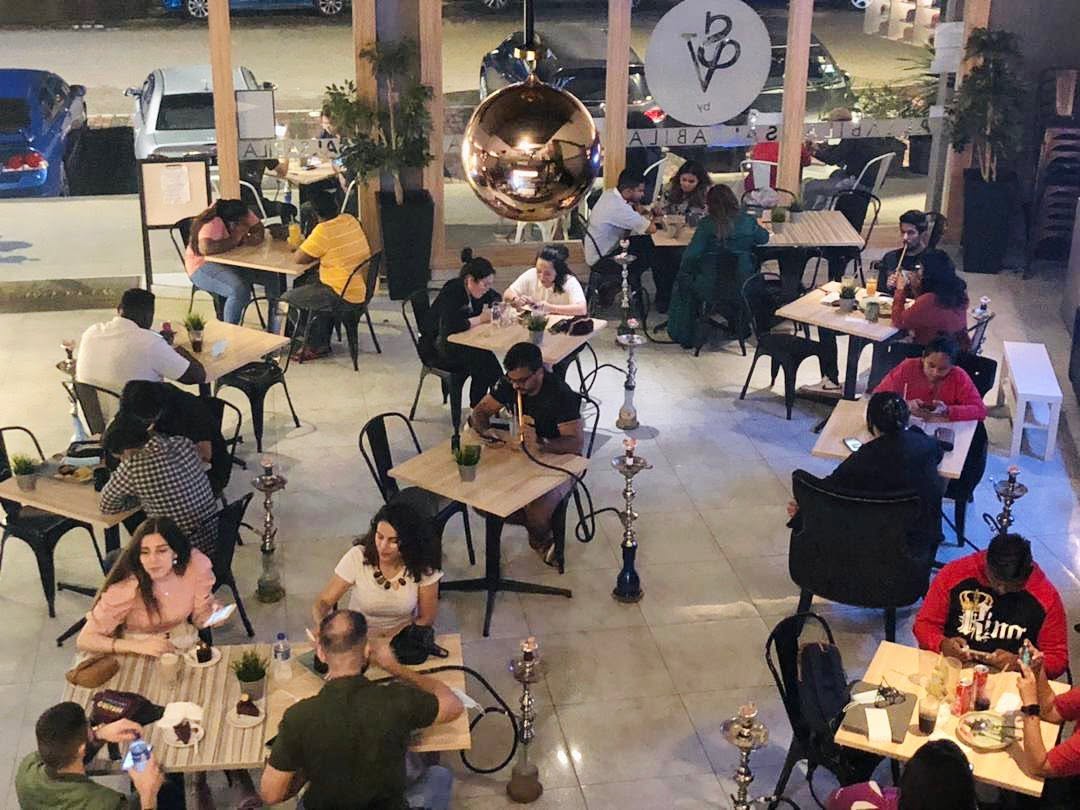 Busy open-air seating with hookahs on the tables at Salsabila Shisha Lounge, Larkin, Johor Bahru