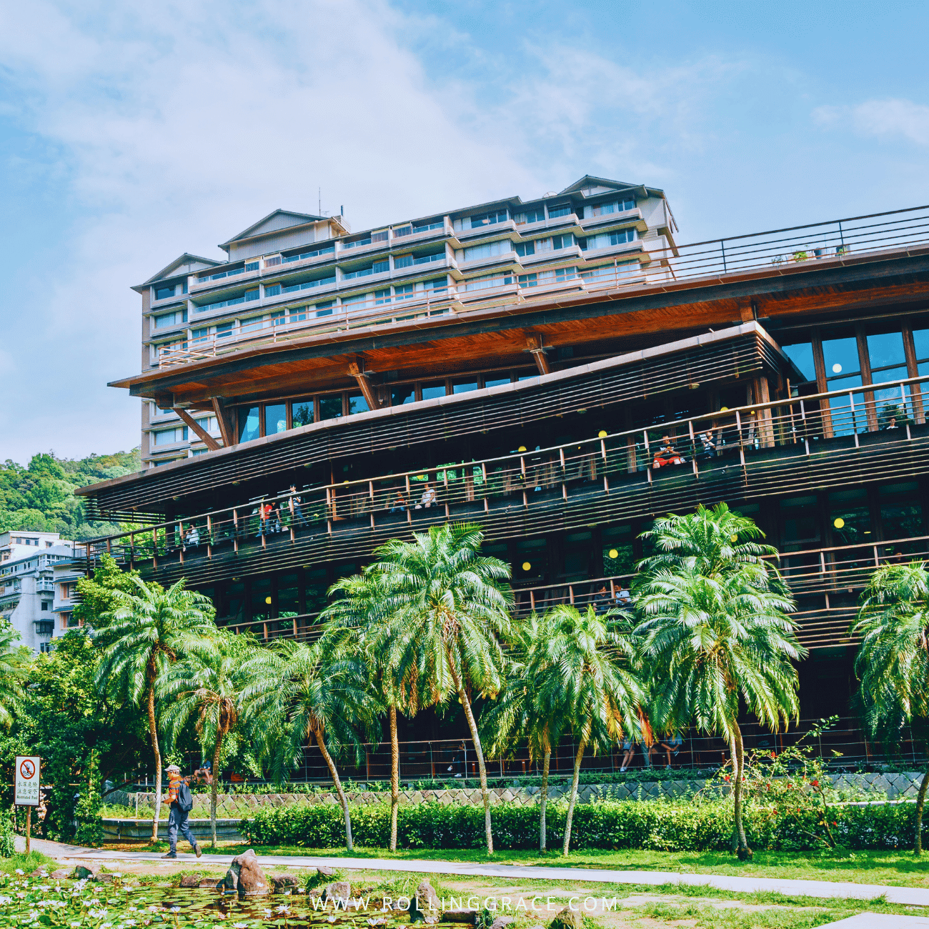 14 Things to Do in Beitou, Taipei: Best Hot Springs & Parks 6 Taipei Public Library Beitou Branch in Beitou, Taipei, a timber building with long balconies behind palm trees