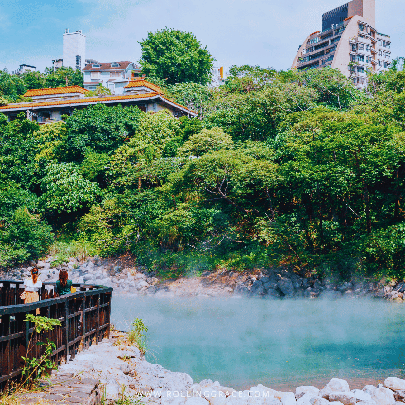 14 Things to Do in Beitou, Taipei: Best Hot Springs & Parks 7 Beitou Thermal Valley in Taipei, a steaming green-blue lake with a viewing railing and city buildings behind
