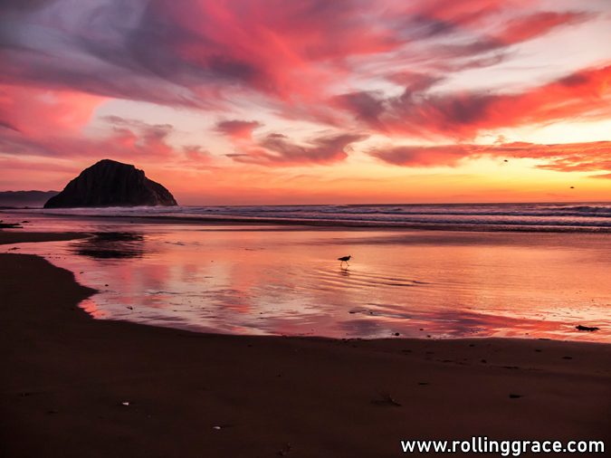 Red sunset over a beach and rocky islet, reflected in wet sand at Kuala Perlis, among free things to do in Perlis